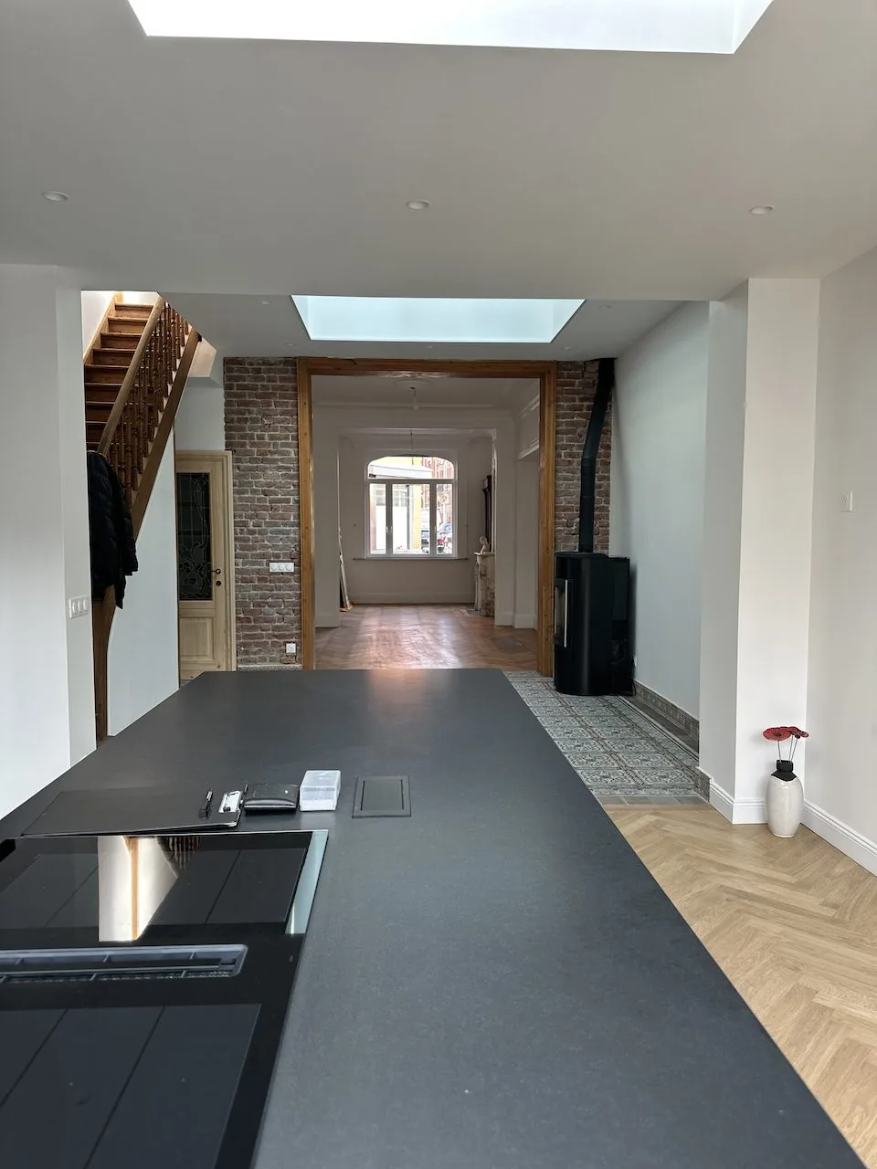 Rénovation clé en main d'une maison de 1908 à La Madeleine - après, la cuisine, son îlot et le mur de brique